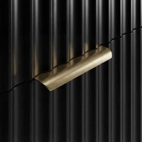 Gold metal handle detail on a black flutrina chest of drawers front with vertical sturdy panel design