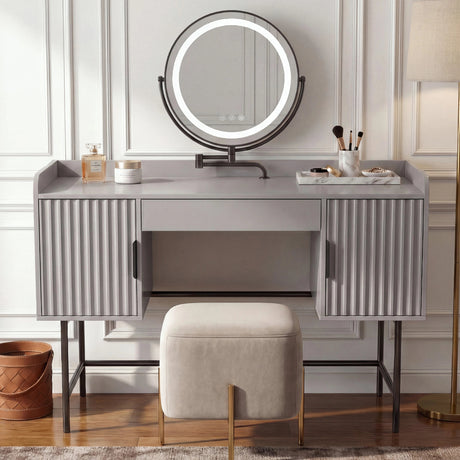 [Grey] front view of the grey fluted vanity with two side cabinets and an amber-toned round LED mirror in a dim room
