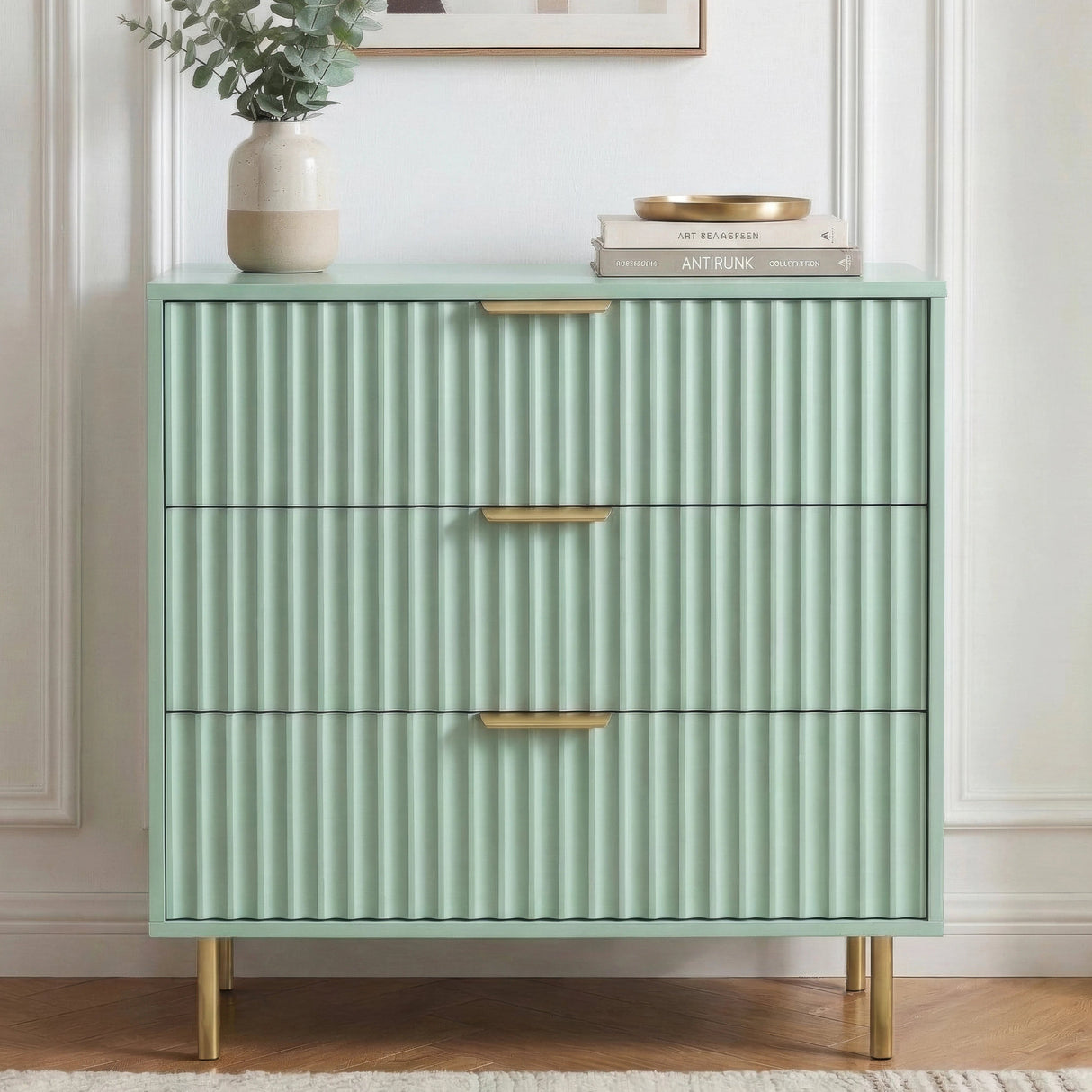 [Sage Green] Flutrina 3 drawer chest with vertical ribbed finish and golden metal support legs showing the sturdy base