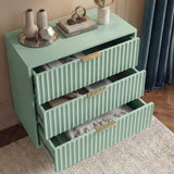 Green chest of drawers with all three drawers extended showing internal storage space and its solid design