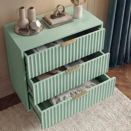 Green chest of drawers with all three drawers extended showing internal storage space and its solid design