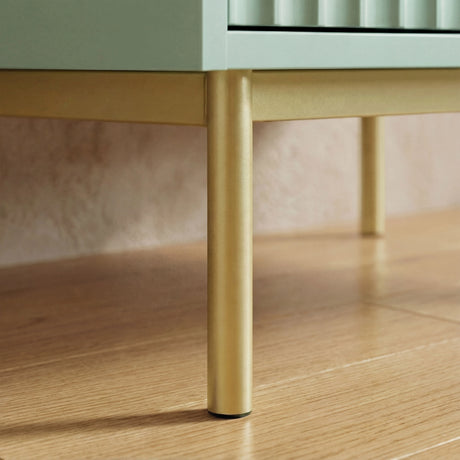Green two door wardrobe golden finish metal leg base detail providing elevated support placed on a wooden flooring