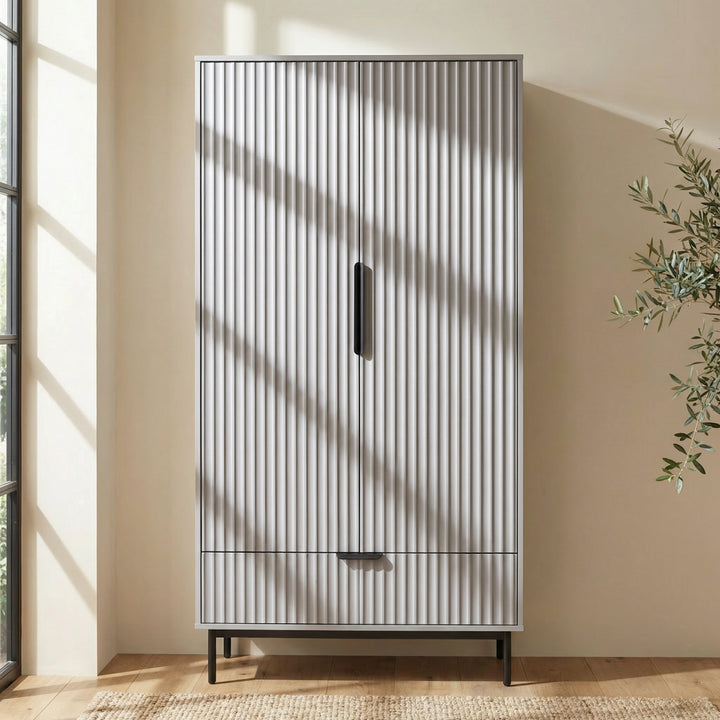 [Grey] painted 2 door wardrobe with drawer storage positioned in neutral room interior with natural bright lighting