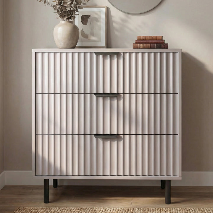 [Grey] Flutrina 3 drawer chest with panels and brushed black metal handles placed in a natural light room