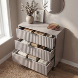[Grey] chest of drawers opened to reveal internal storage layout across three levels with black metal handles