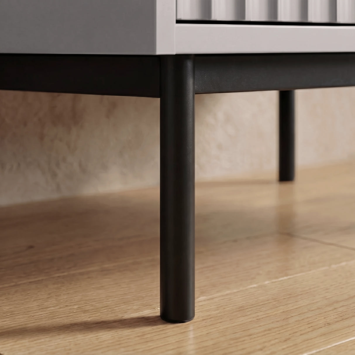[Grey] flutrina wardrobe raised black metal leg detail supporting cabinet structure placed on a wooden flooring