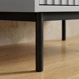 Grey flutrina wardrobe raised black metal leg detail supporting cabinet structure placed on a wooden flooring