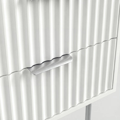 Close detail of silver metal drawer handle and legs mounted on white flutrina cabinet front