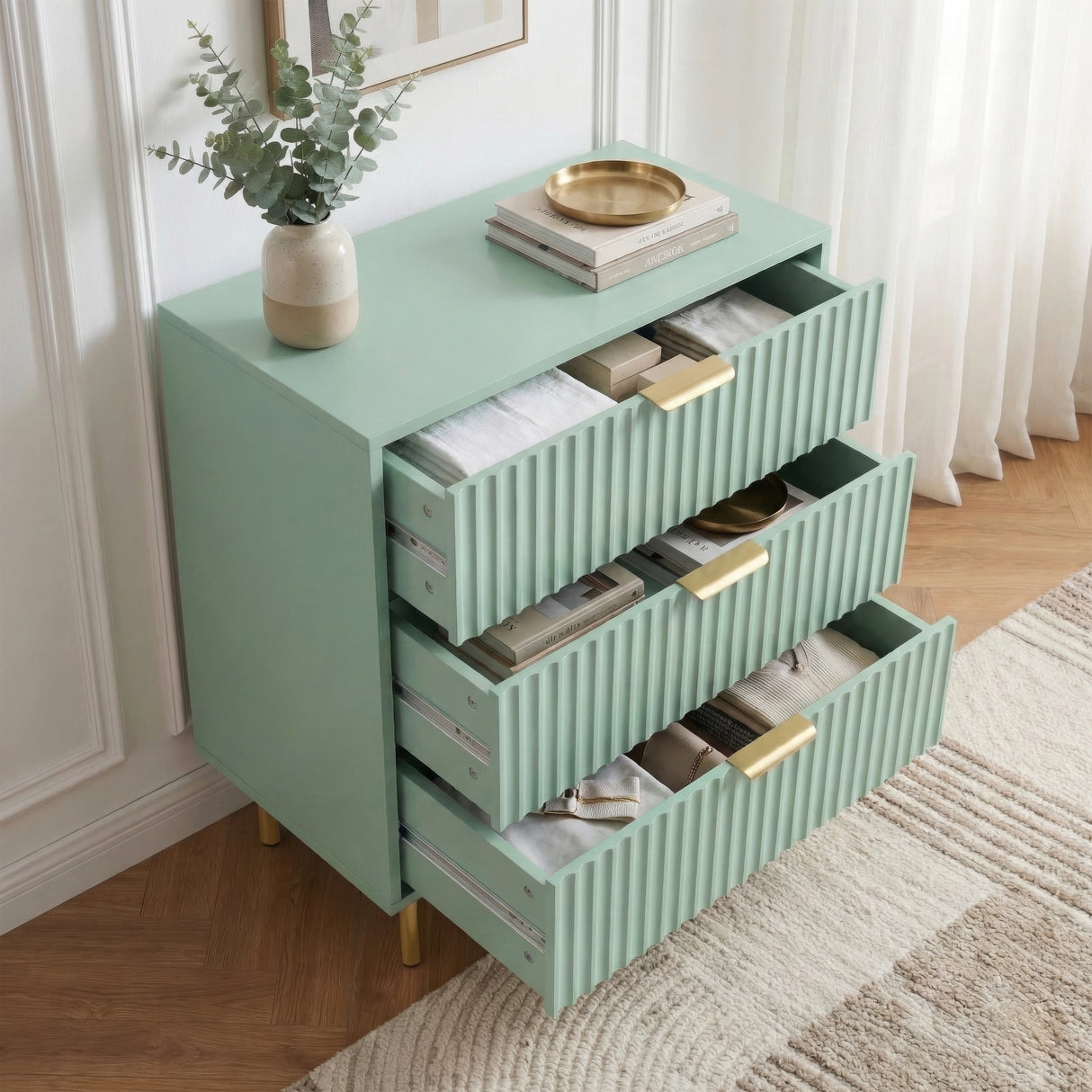 [Sage Green] chest of drawers with all three drawers extended, showing internal storage space and its solid design