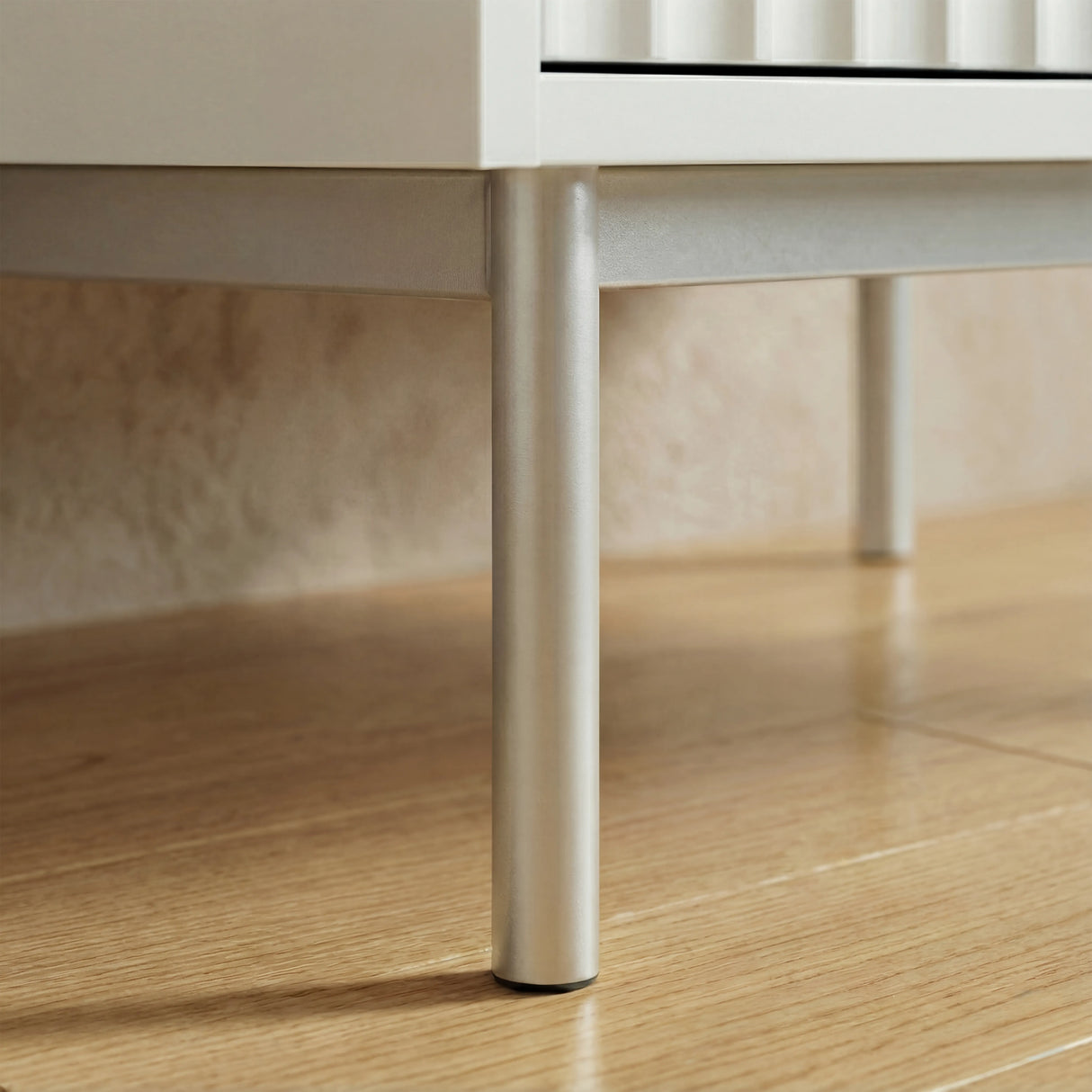 White two door wardrobe silver metal leg detail with raised base displaying its unique design and sturdy base