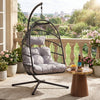 [Black] Hanging egg chair with gray cushions on a balcony with plants and a small table