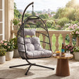 [Black] Hanging egg chair with gray cushions on a balcony with plants and a small table