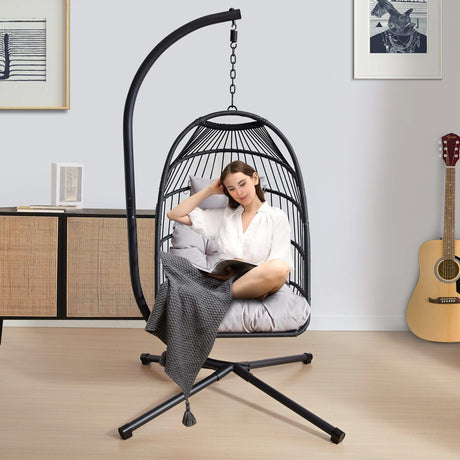 [Black] Black rattan garden egg chair with cushion in living space with guitar and shelves