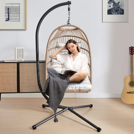 [Natural] Natural foldable garden egg chair with cushion indoors with woman reading book