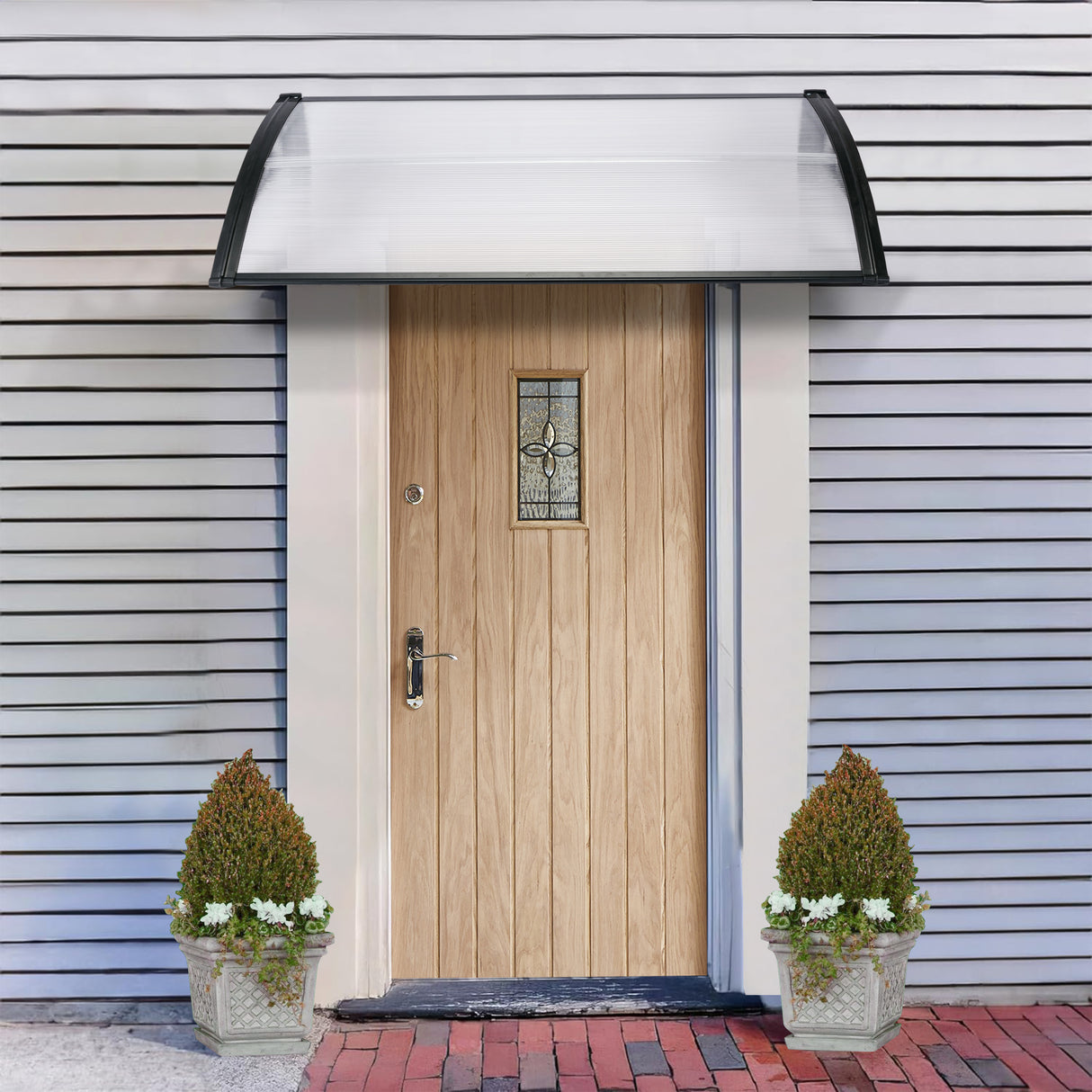 Front door canopy modern with clear polycarbonate roof and black frame for weather protection.