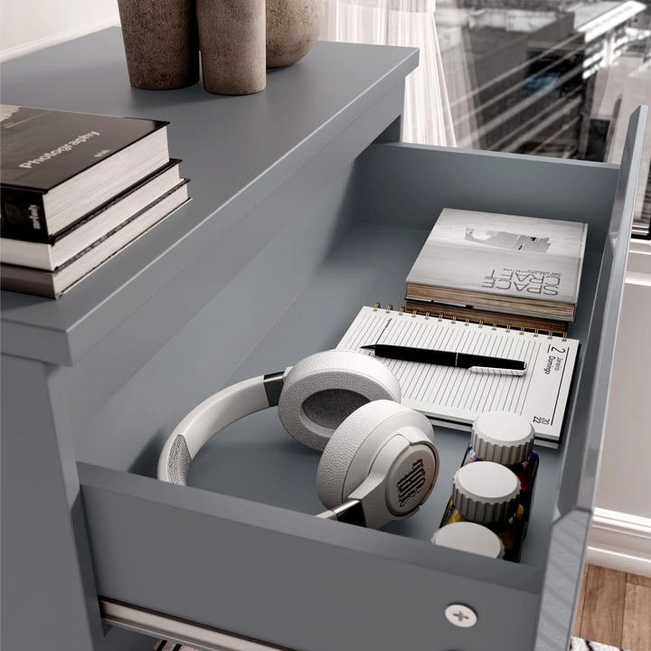 [Grey] Top drawer of grey High Gloss Chester Drawers with books, headphones, and stationery, showcasing practical storage use.