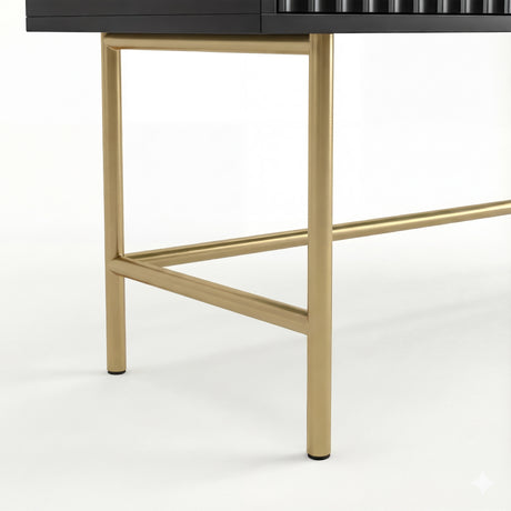 View of gold metal legs supporting a black vanity makeup table, with the modern and sleek design
