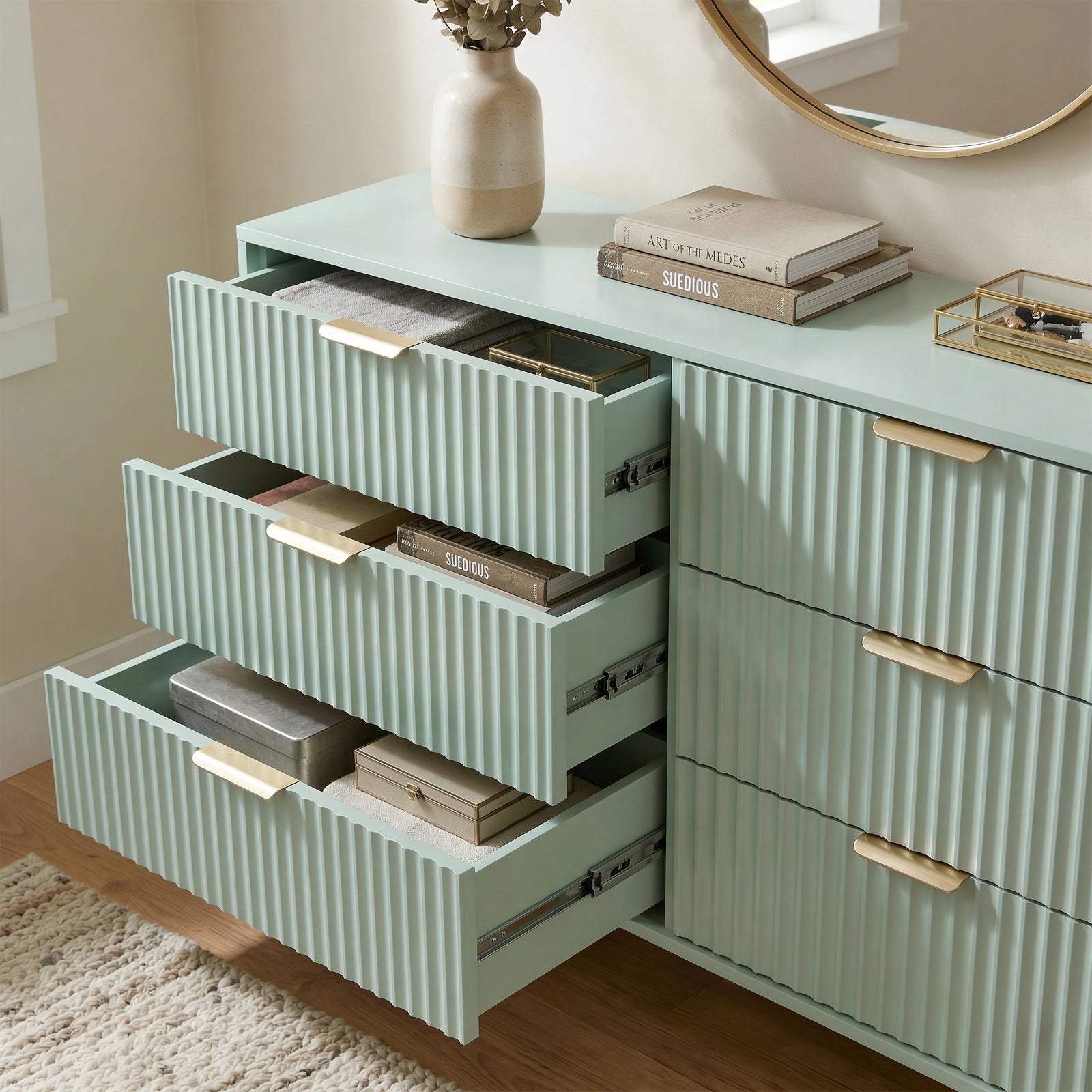 [Sage Green] painted chest with three drawers extended, highlighting internal storage layout with metallic smooth runner hardware