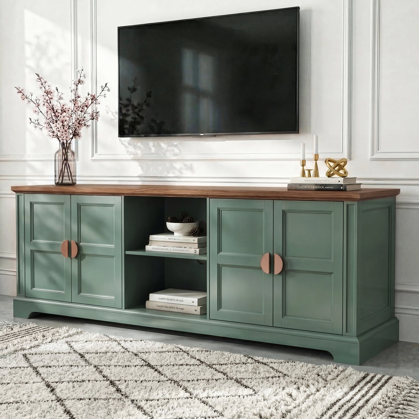 [Green | 170cm] Bellford TV unit from a low side angle on a light floor with cherry blossom vase and wall-mounted TV
