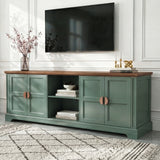 [Green | 170cm] Bellford TV unit from a low side angle on a light floor with cherry blossom vase and wall-mounted TV