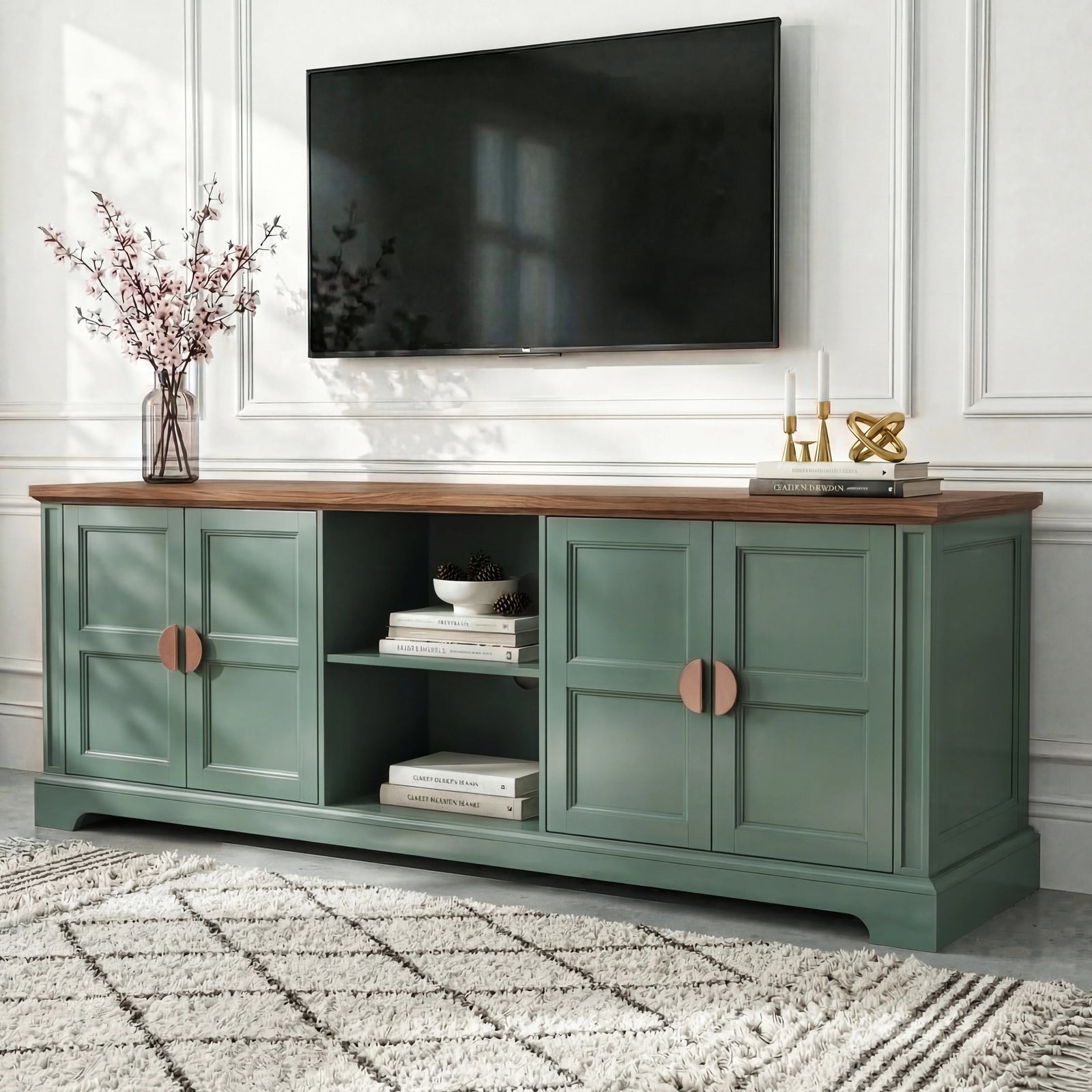 [Green | 170cm] Bellford TV unit from a low side angle on a light floor with cherry blossom vase and wall-mounted TV