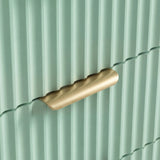 Close view of green flutrina surface texture with golden metal handle of six chest of drawers