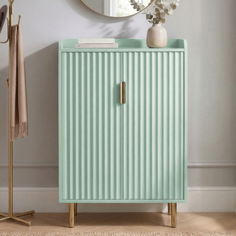 [Green] Flutrina shoe cabinet with ribbed double doors, gold bar handles, and gold metal legs styled in a hallway with mirror and vase
