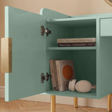Close-up view of a green vanity dressing table with open shelves, displaying neatly arranged books and decorative items