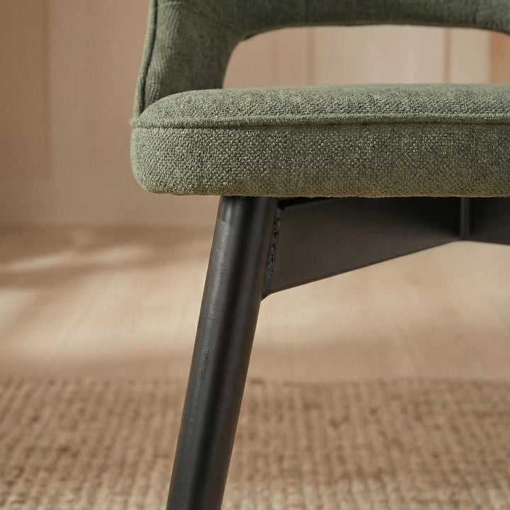[6 Seater | Green] Close shot of green Xylon chair side, fabric weave and tapered black leg base