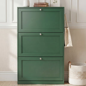 [Green] Shaker Shoe Cabinet closed three-door flip-front unit against white panelled wall with woven basket and linen tote bag alongside