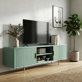 Green TV stand with vertical fluted doors and silver legs, providing a modern storage solution for colorful interiors.