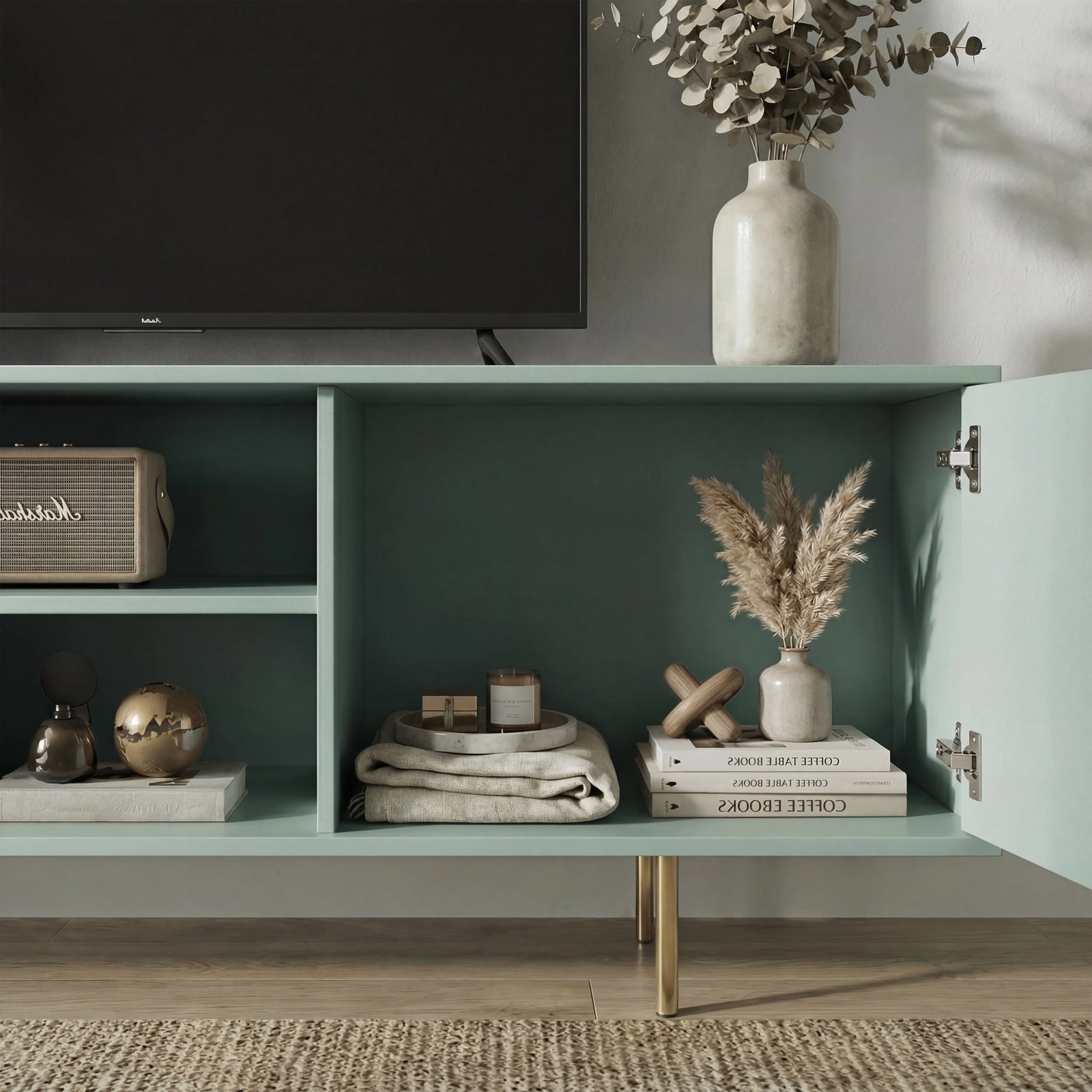 [Sage Green]  Interior of sage green Flutrina TV unit, both ribbed doors open showing rattan speaker, gold ball and pampas vase