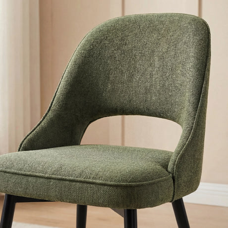 Close-up of green dining chair with black metal legs and comfortable upholstery, part of Xylon dining set.