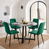 [Green | Set of 4] Velvet dining chairs around a round grey table, with curved tufted backs, armless seats and black legs.