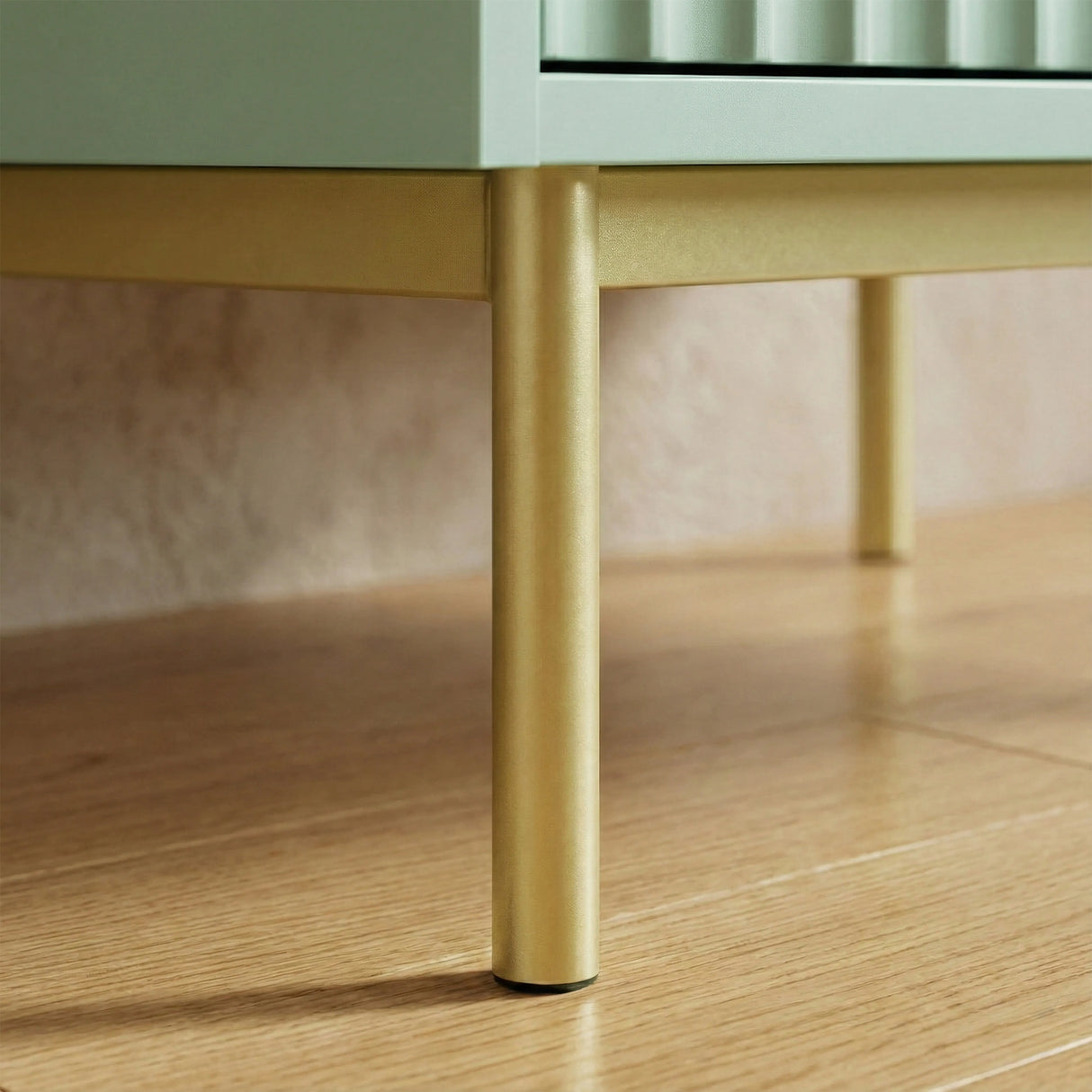 Green wardrobe three door cabinet raised on golden finish metal legs with sturdy lower frame construction