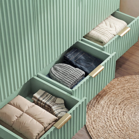 Green wardrobe drawer storage extended to reveal the internal layout for clothing