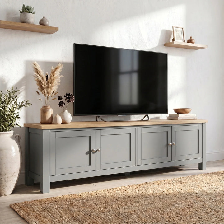 [Grey] 180cm Shaker TV Unit with Storage three-quarter view in styled living room with oak top, four shaker doors, brushed nickel knobs and pampas grass decor