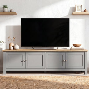 [Grey] 180cm Shaker TV Unit with Storage front view showing four shaker doors with brushed nickel knobs, oak top and floating shelves on white wall behind