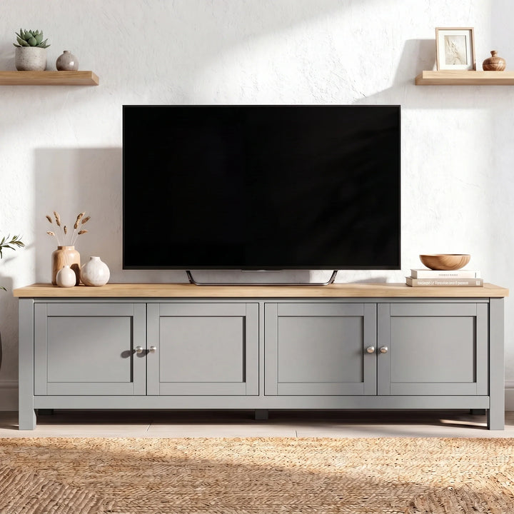 [Grey] 180cm Shaker TV Unit with Storage front view showing four shaker doors with brushed nickel knobs, oak top and floating shelves on white wall behind