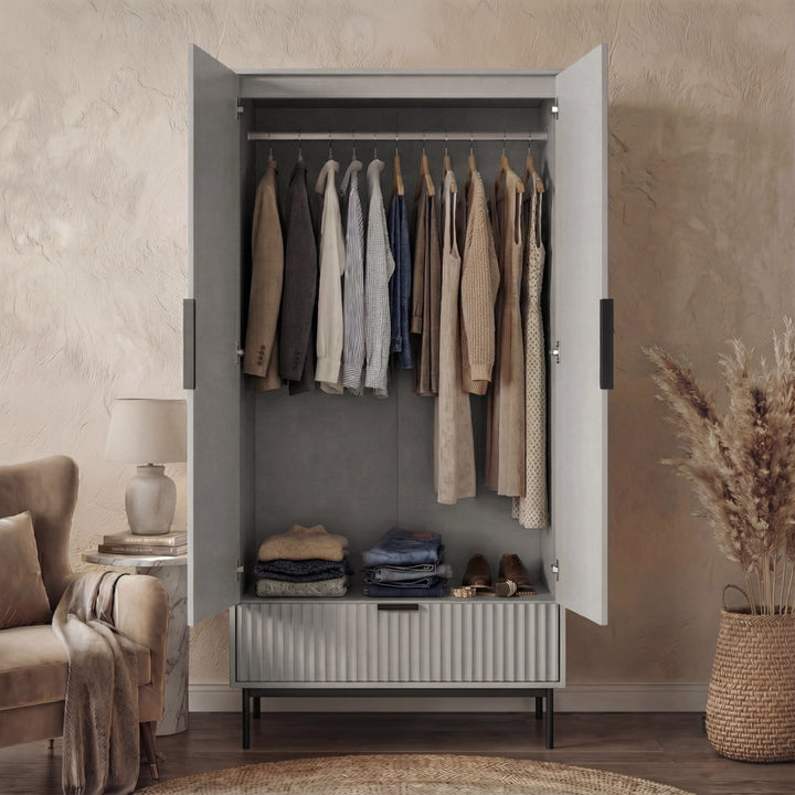 [Grey] flutrina design double wardrobe containing hanging storage space and a bottom drawer placed in a room with neutral decor