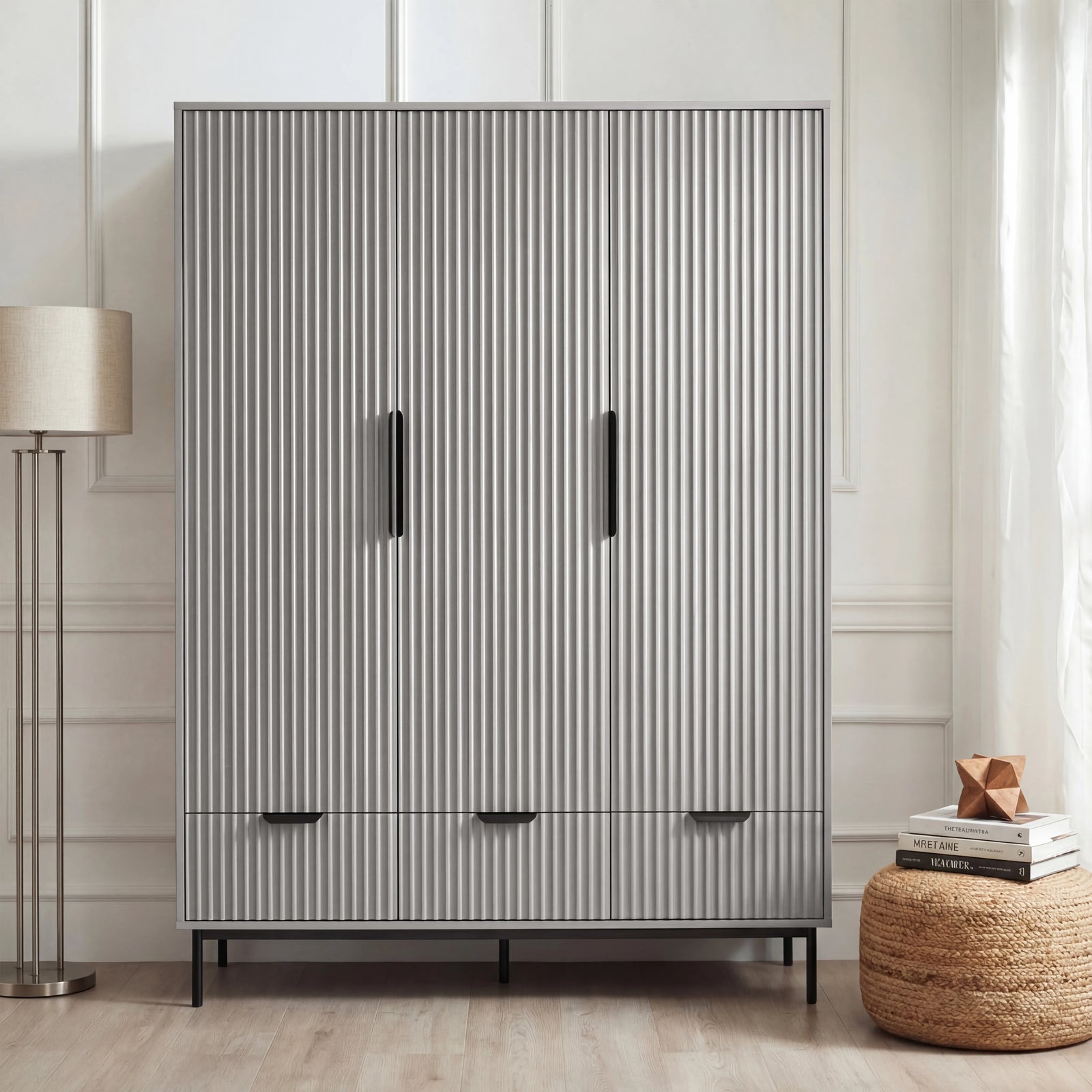 [Grey] flutrina design triple wardrobe with drawers and black handles placed against a wall in a bedroom