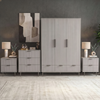 Grey four piece bedroom furniture set with a wardrobe, chest of drawers, and two bedside cabinets