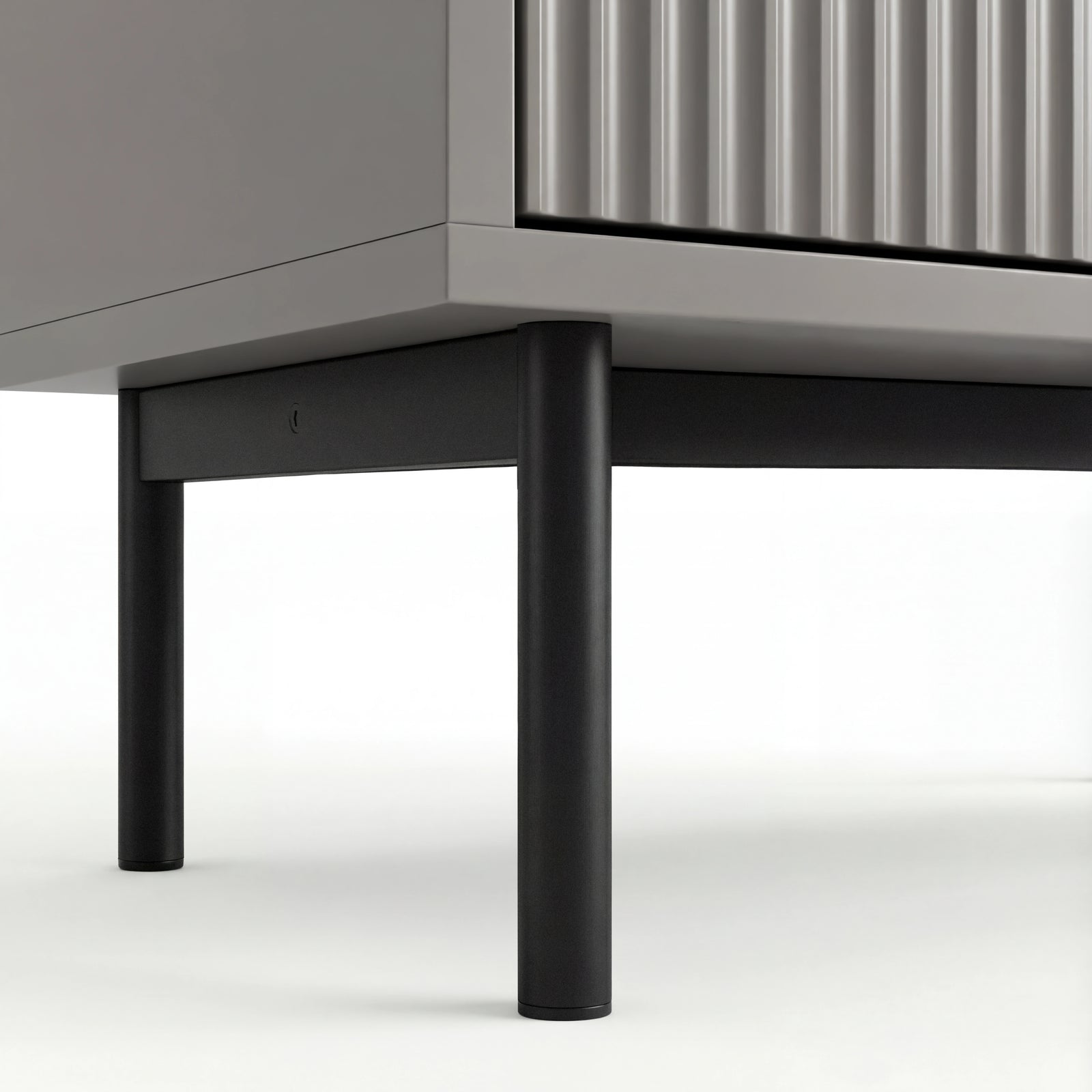 [Grey] Lower section of grey 5 chest of drawers with black metal legs and corner of the cabinet base