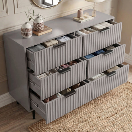 [Grey] bedroom drawers partially opened to reveal internal compartments and storage capacity