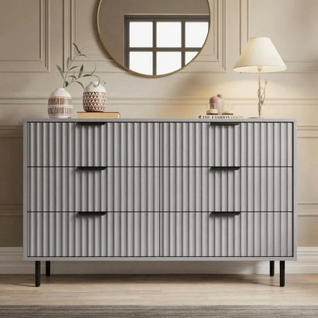 [Grey] Front view of 6 drawer wide chest with vertical panel detailing and black metal handles