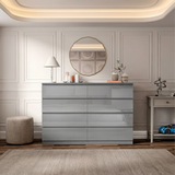 [grey] high gloss 8 drawer chest centred in room with round gold mirror and pendant light