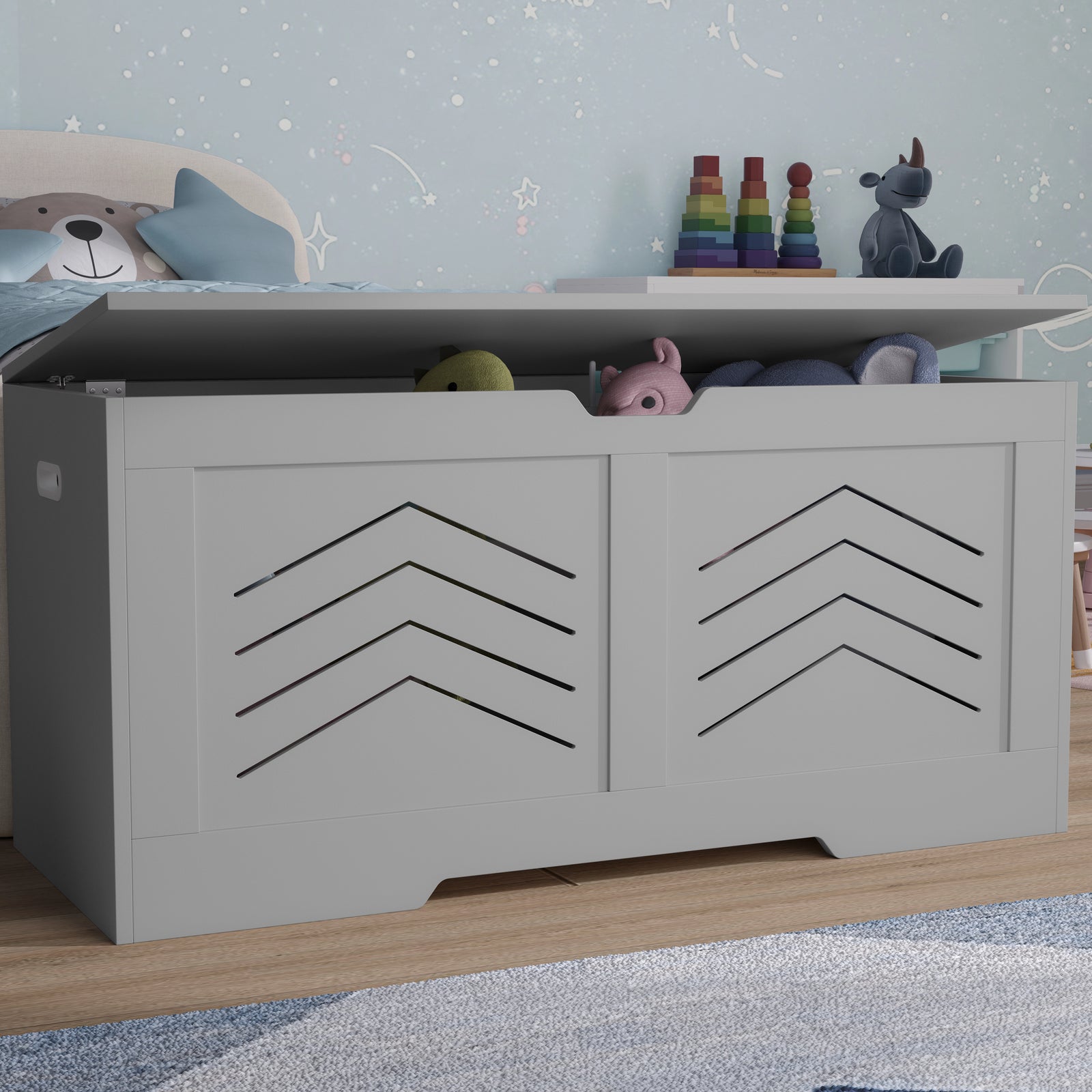 [Grey] Grey storage chest with two chevron-cut front panels, navy star wallpaper behind in child's room