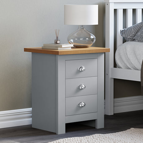 Grey bedside table 3 drawer, top surface adorned with books for a stylish, organized look