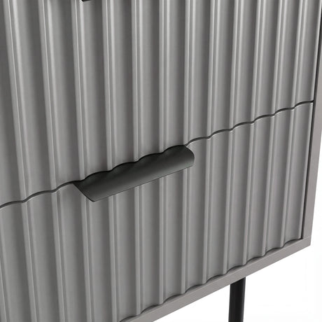 Close detail of the black metallic handle fixed to the grey flutrina design drawer surface of a nightstand