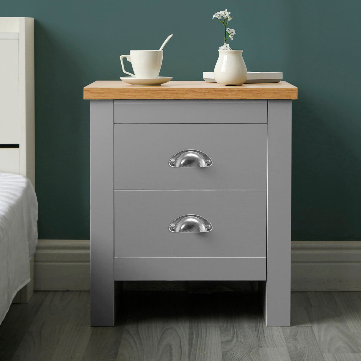 Grey bedside table with two drawers and chrome handles, featuring a wooden top for modern decor.